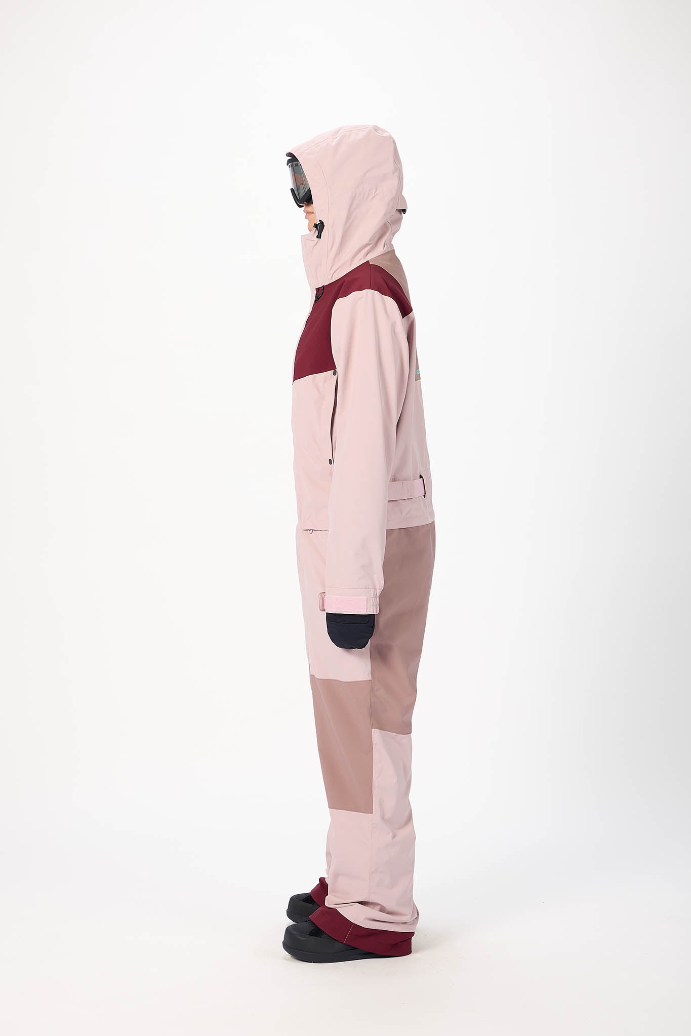 Person wearing a pink and red hoodie with matching pants on a white background
