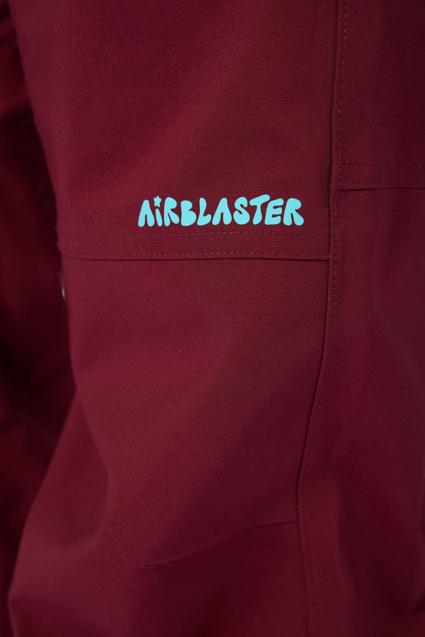 Maroon jacket with 'Airblaster' logo on a pocket