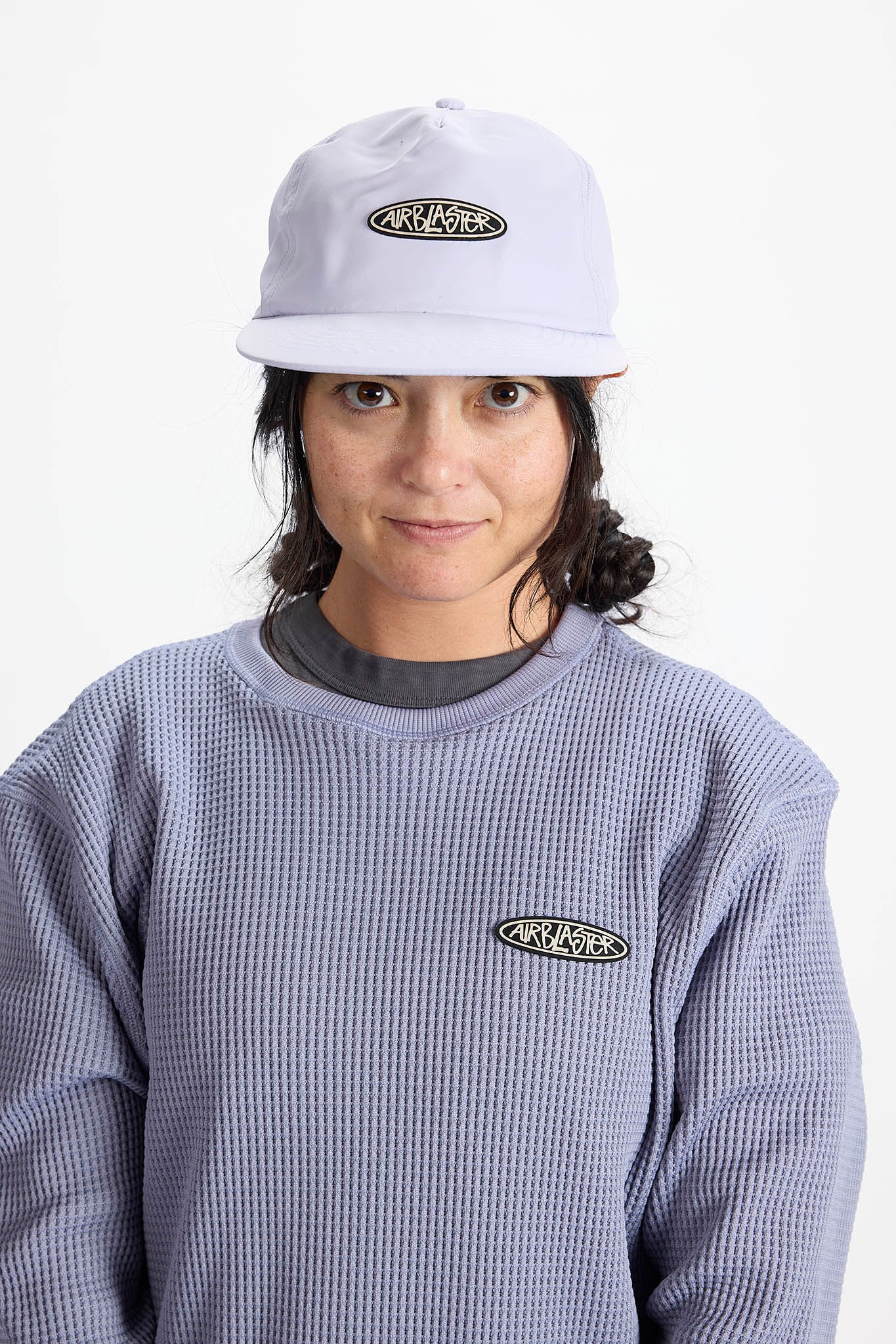 model wearing a lavender baseball cap
