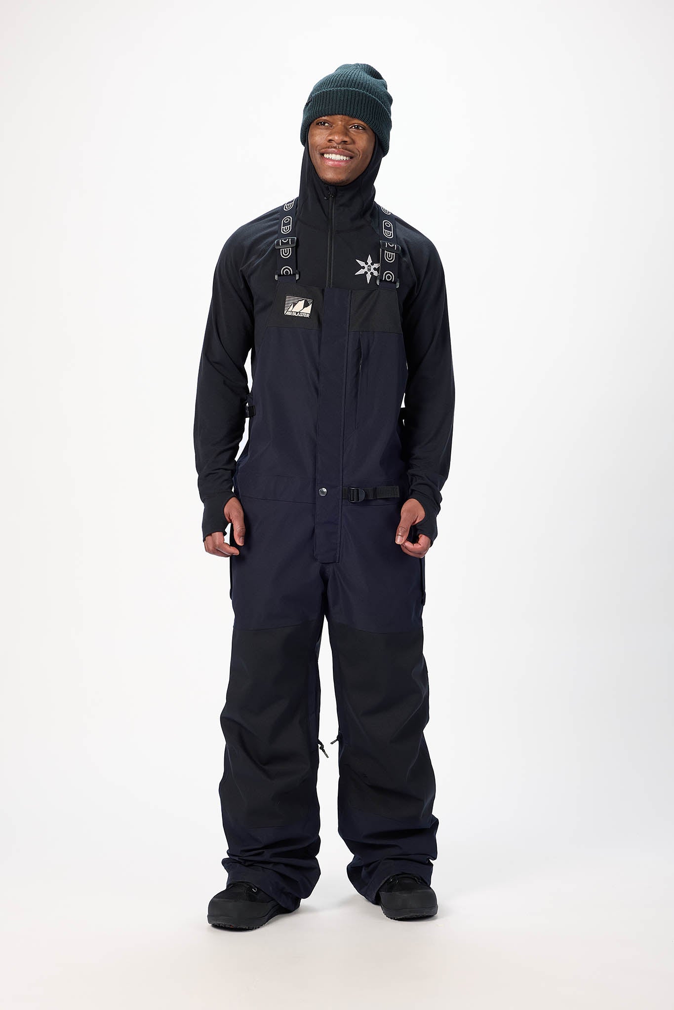 Person wearing a black snowmobile suit with a hood on a white background