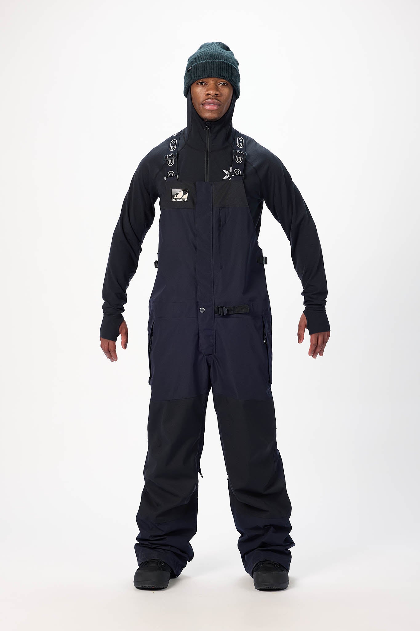 Person wearing a black snowmobile suit with a hood on a white background