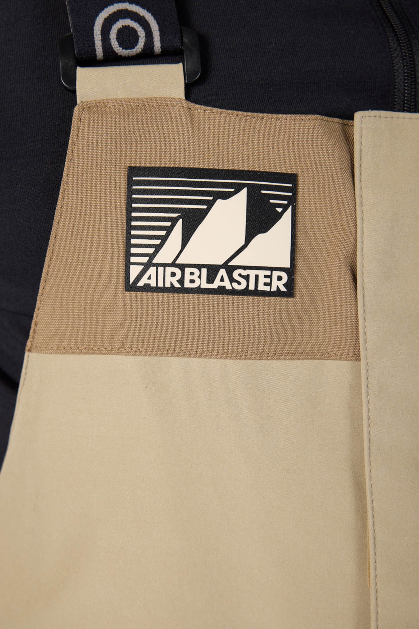Beige apron with 'Fair Blaster' logo on a black background