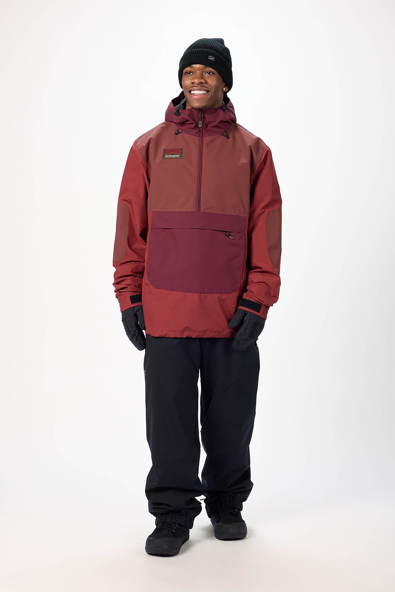 Person wearing a red jacket and black pants on a white background