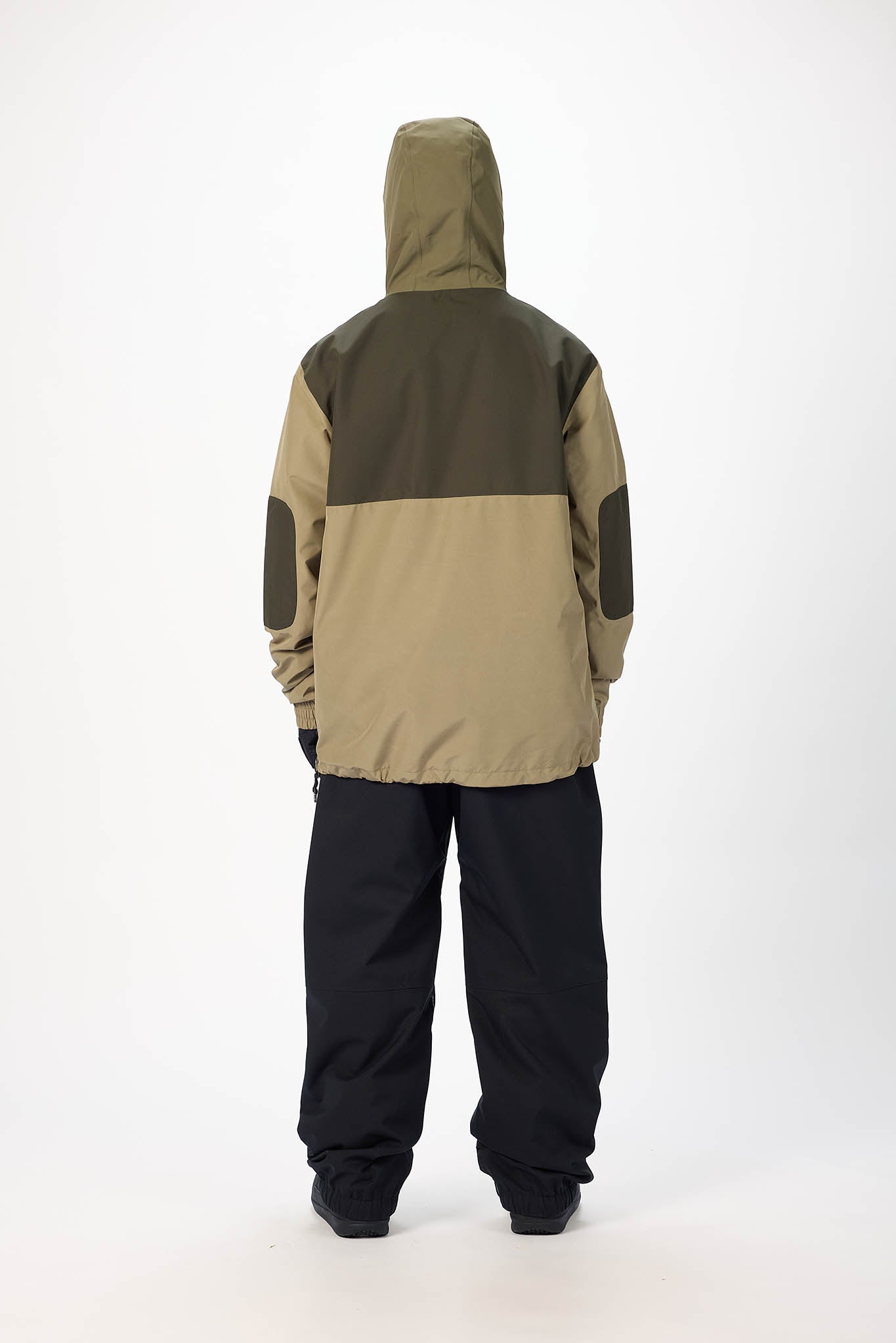 Two-tone jacket with green and beige sections on a white background