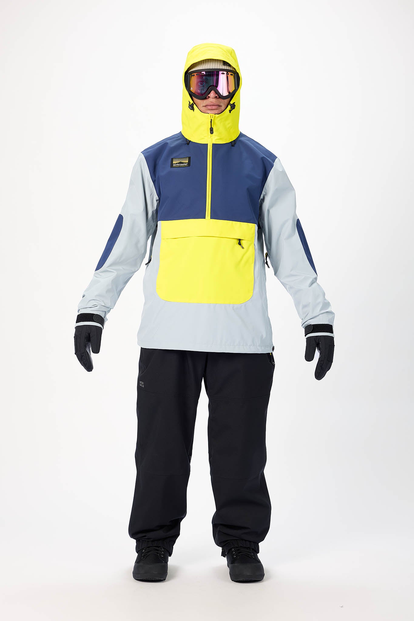 Person wearing a colorful snowboarding outfit with a blue and yellow jacket on a white background