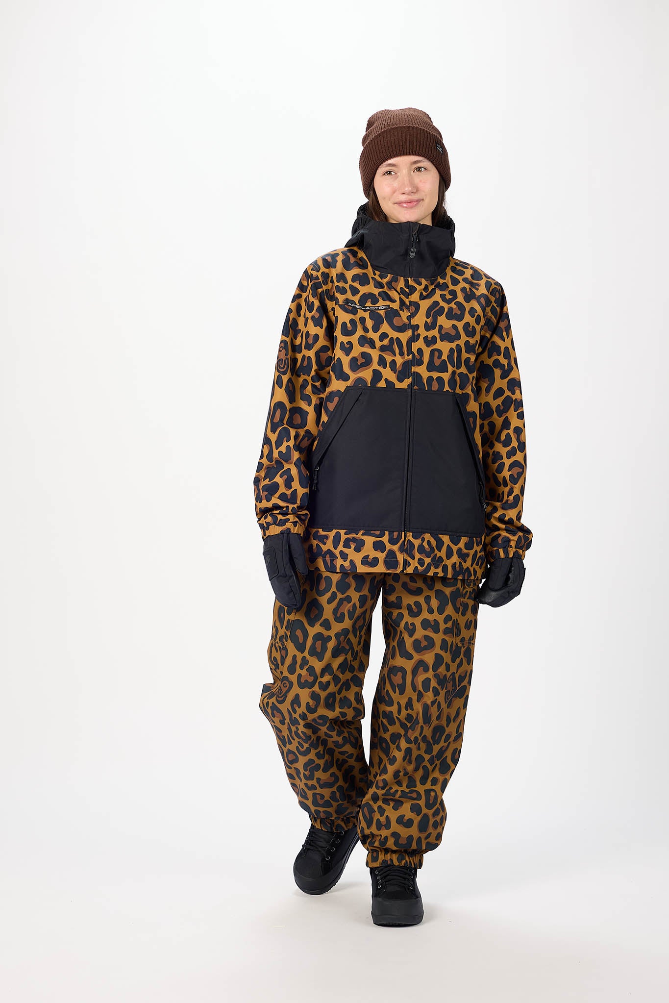 Person wearing a leopard print snowsuit on a white background