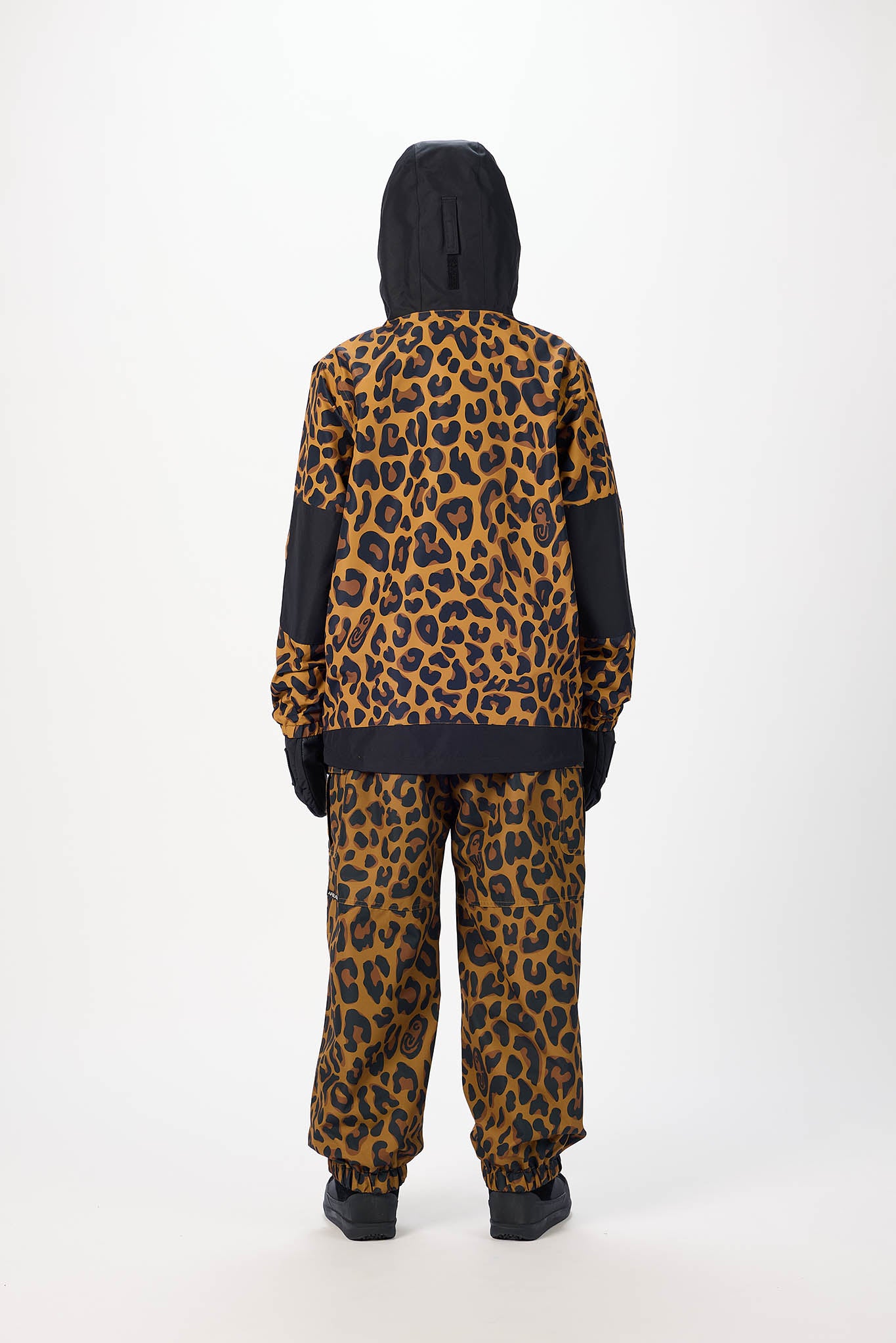 Person wearing a leopard print hoodie and pants set on a white background