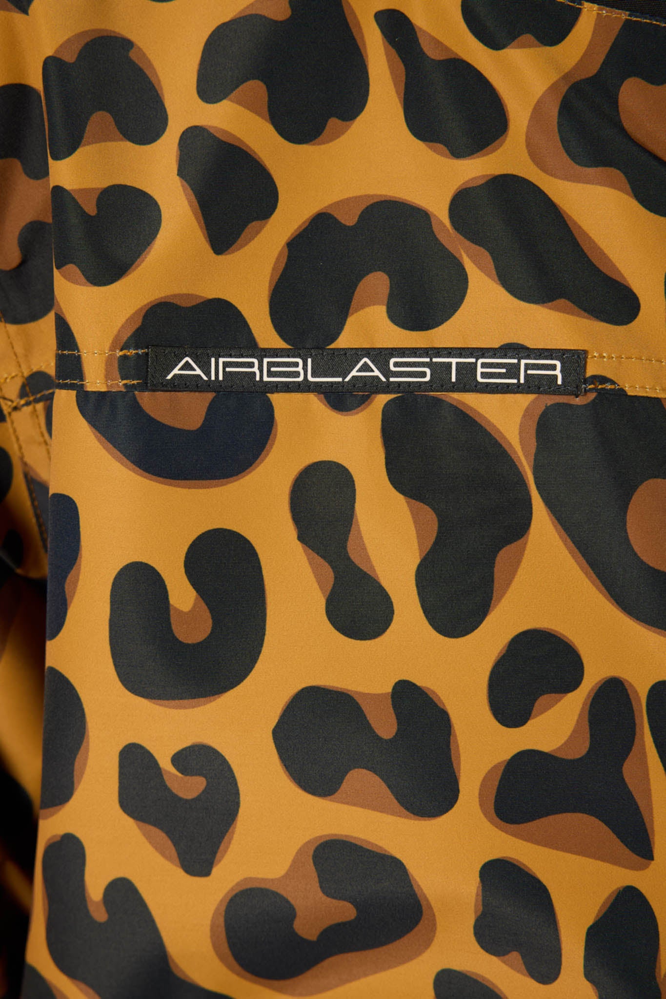 Leopard print jacket with 'Airblaster' logo on a close-up view