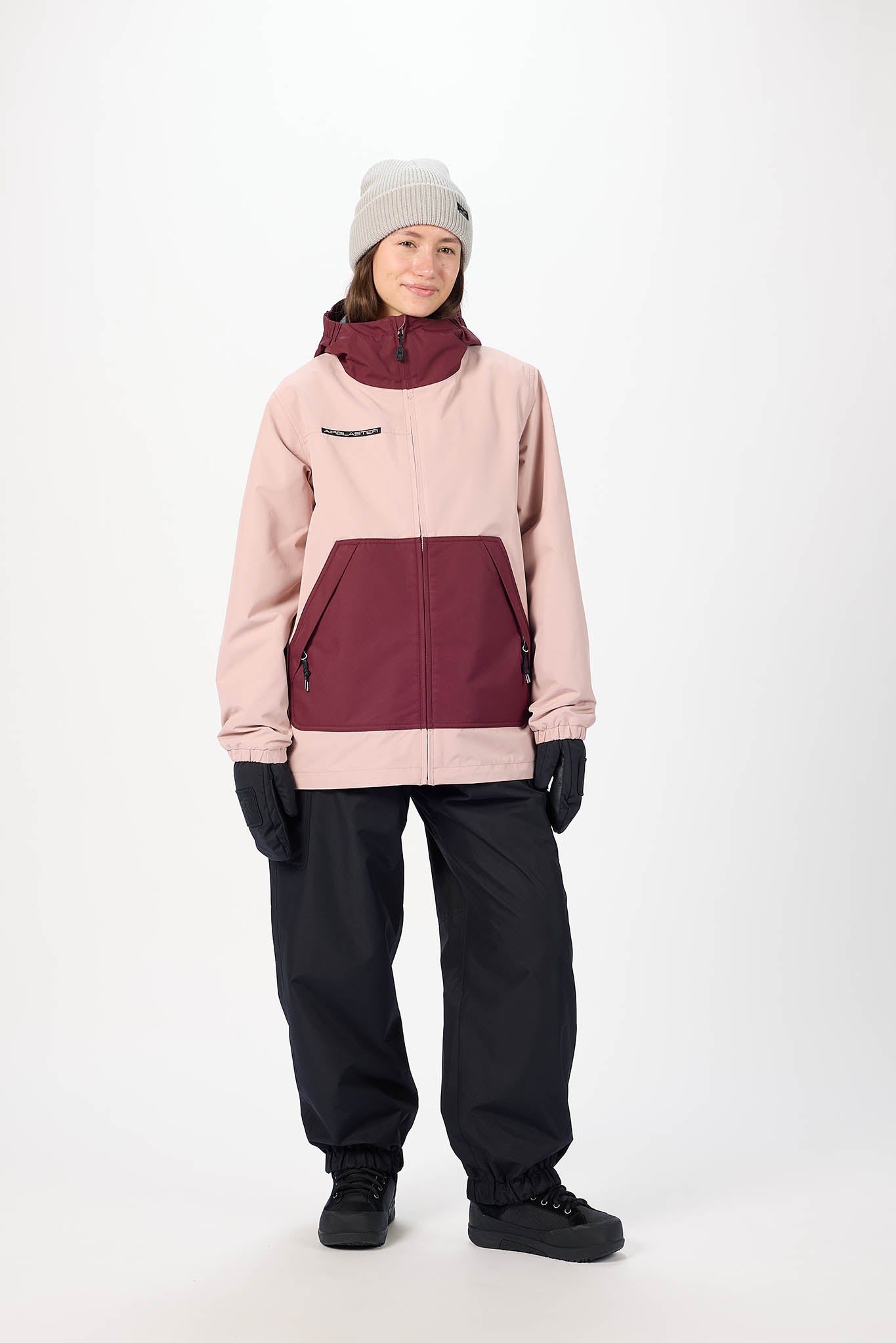 Person wearing a two-tone jacket with pink and maroon colors on a white background