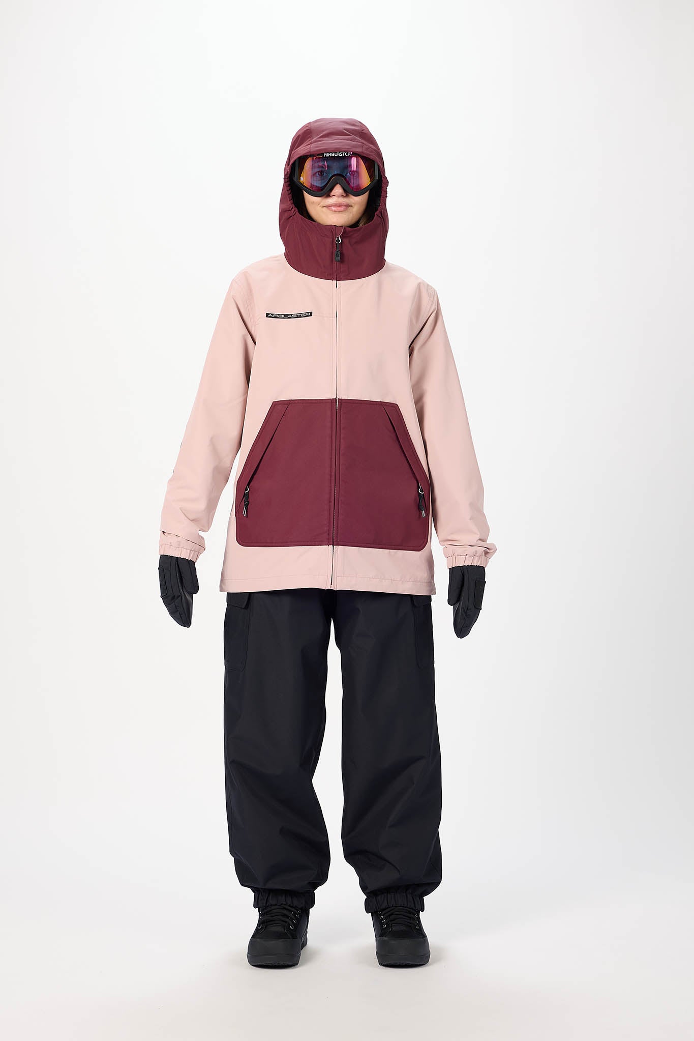 Person wearing a two-tone pink and maroon jacket with black pants on a white background