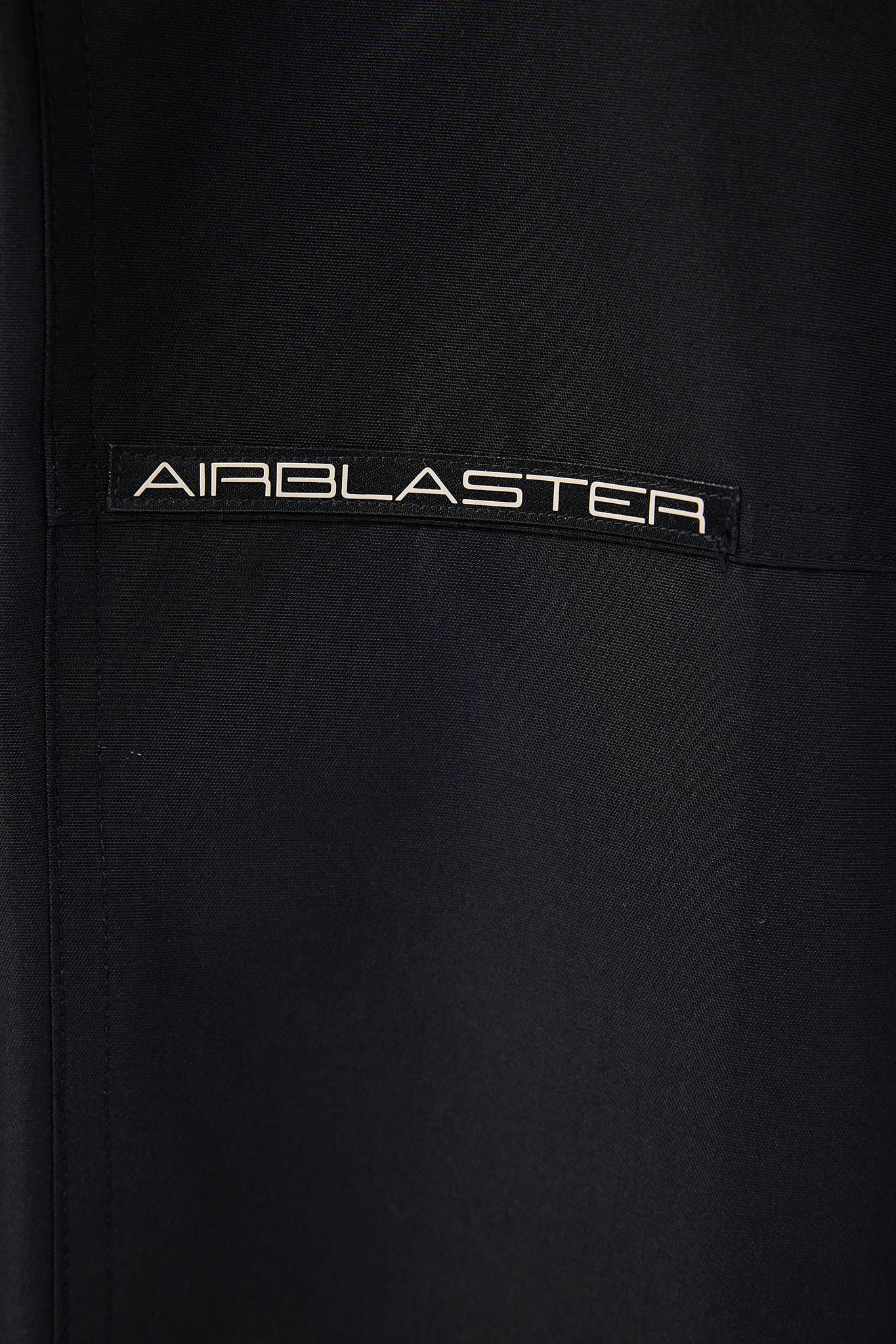 Black jacket with 'AIRBLASTER' logo on a black background