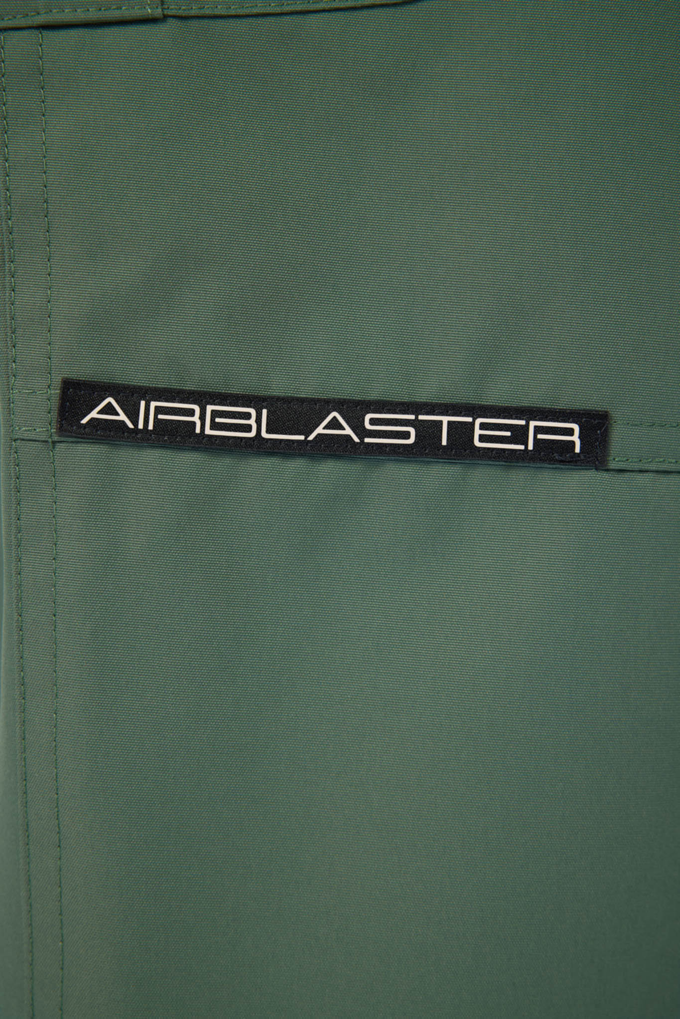 Green fabric with 'AIRBLASTER' logo tag