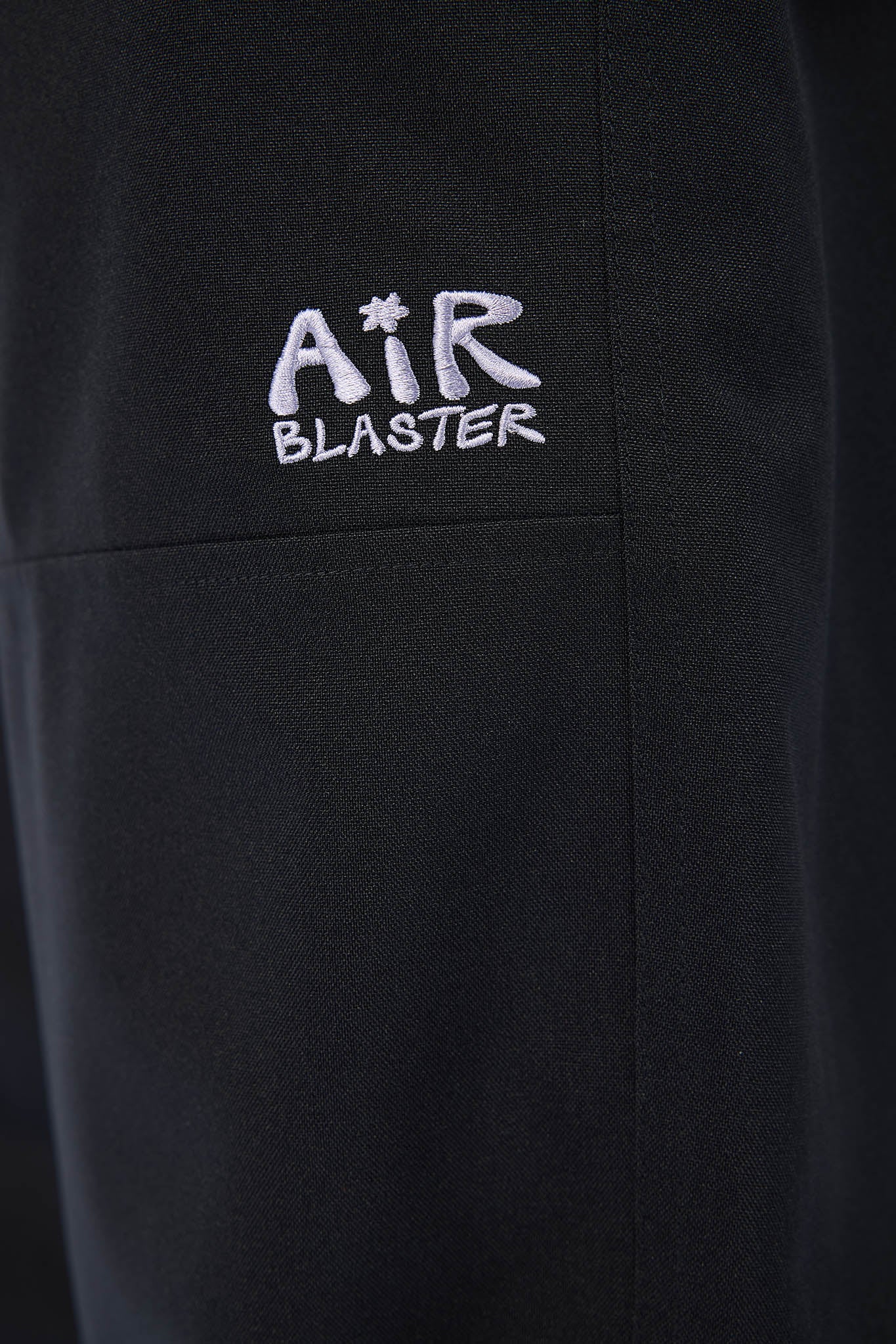 Black jacket with 'Air Blaster' logo on a dark background