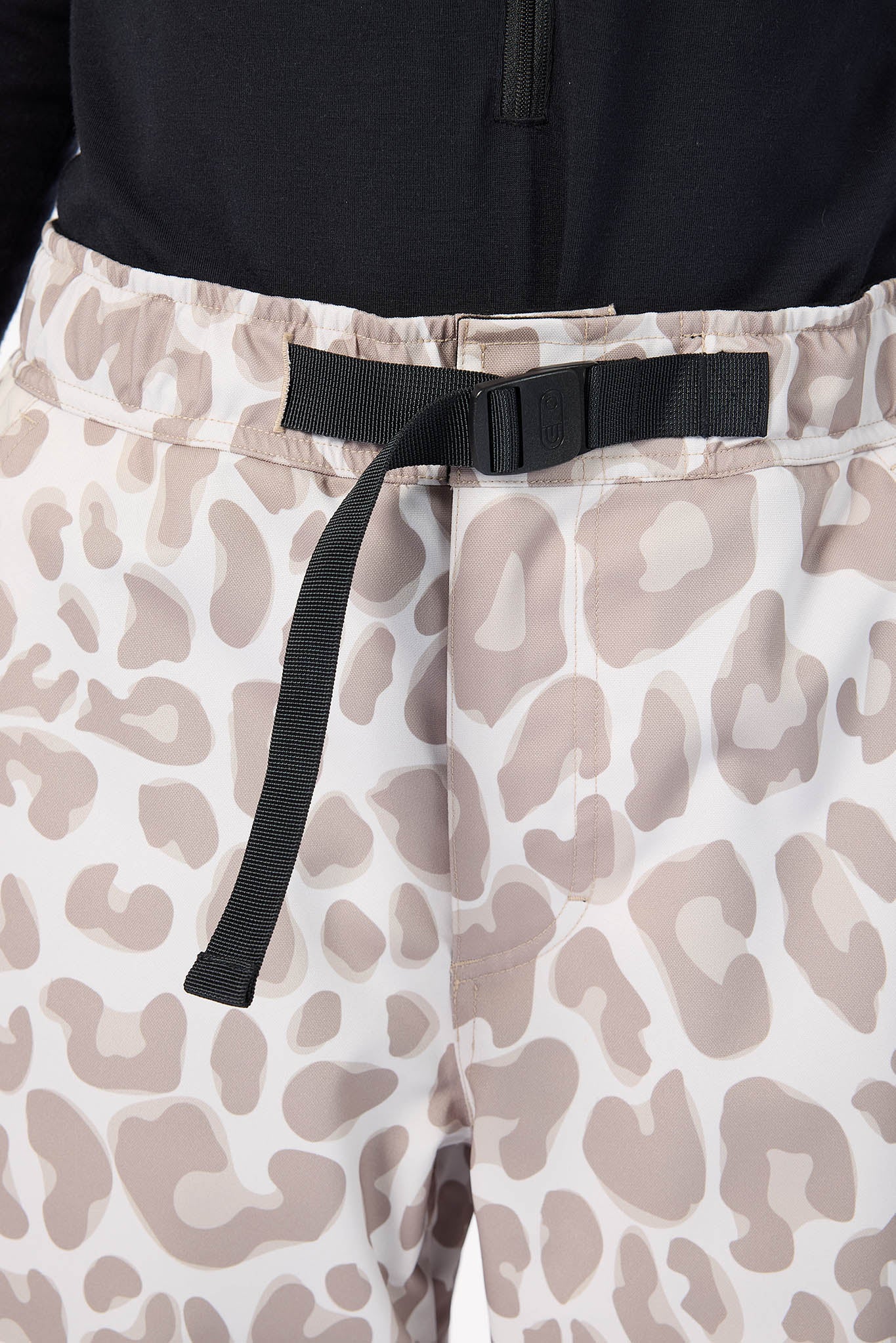 Leopard print pants with a black belt and black top.