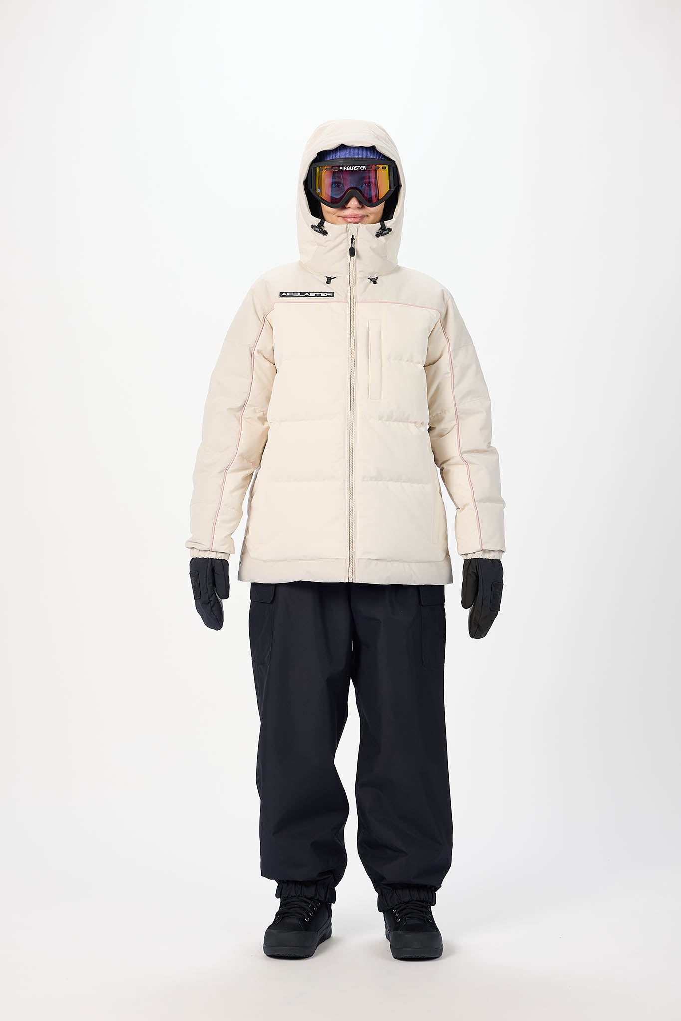 Person wearing a white puffer jacket and black pants on a white background