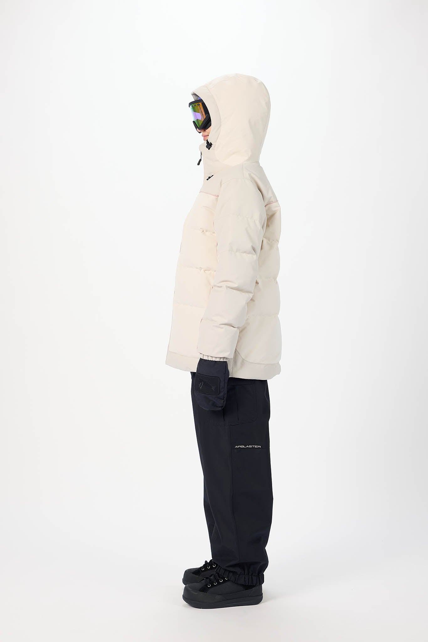 Person wearing a white puffer jacket and black pants on a white background