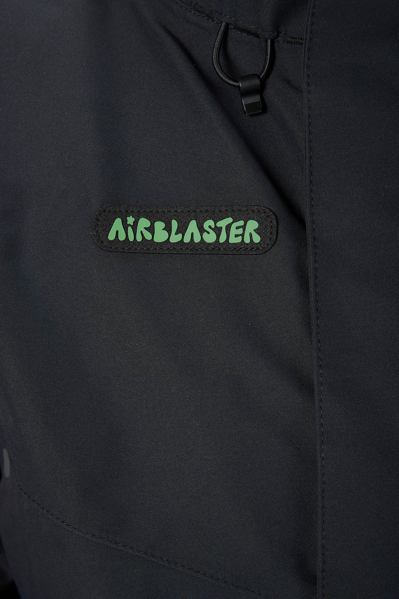 close up of black jacket and logo on the side