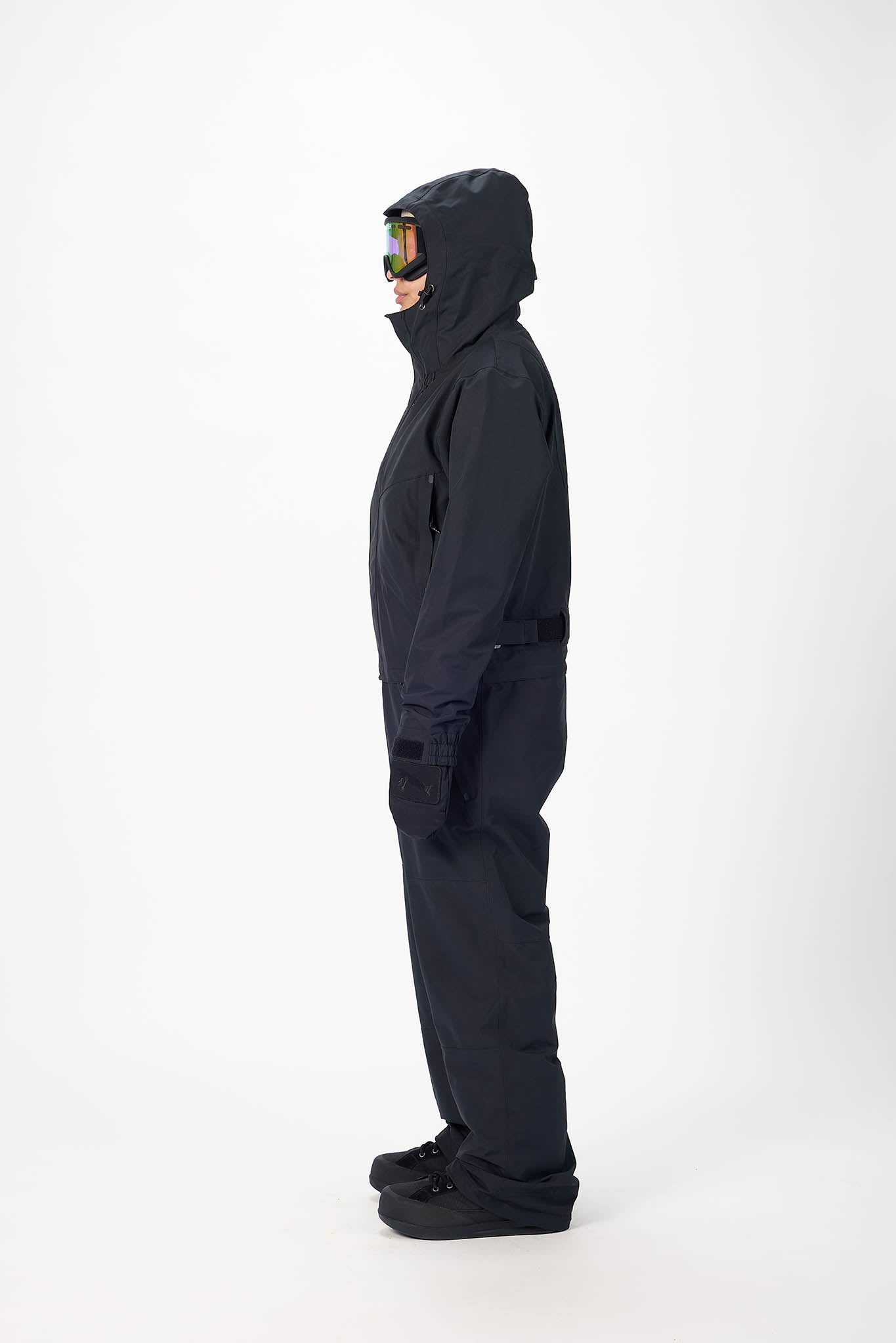 Person wearing a black snowsuit on a white background
