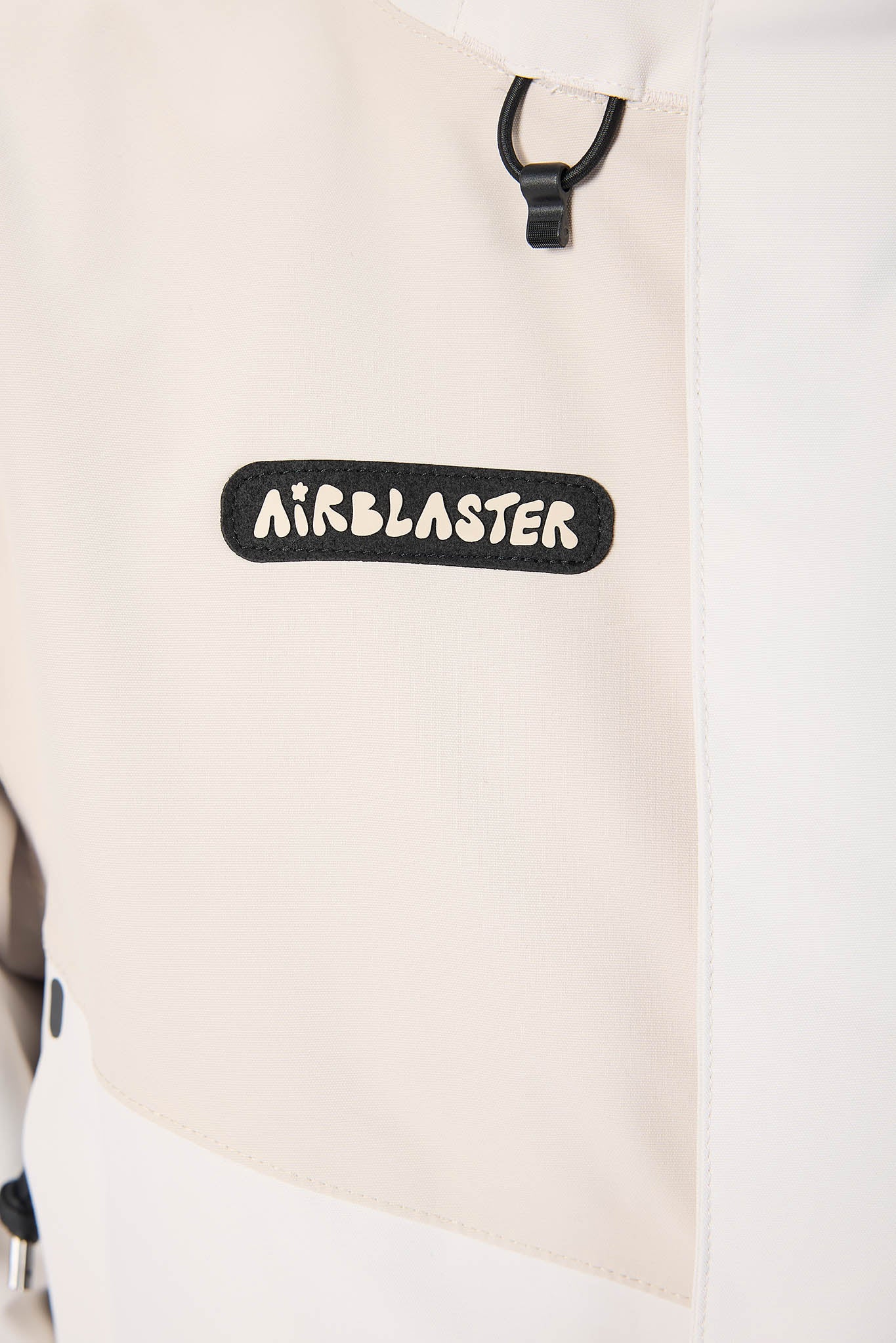 Beige backpack with 'Airblaster' logo on a white background