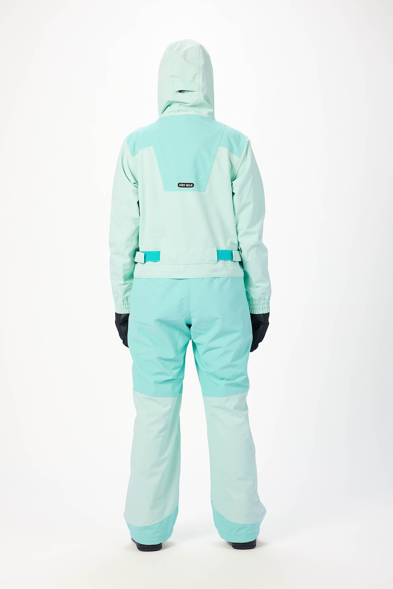 view from behind Person wearing a mint snowsuit on a white background