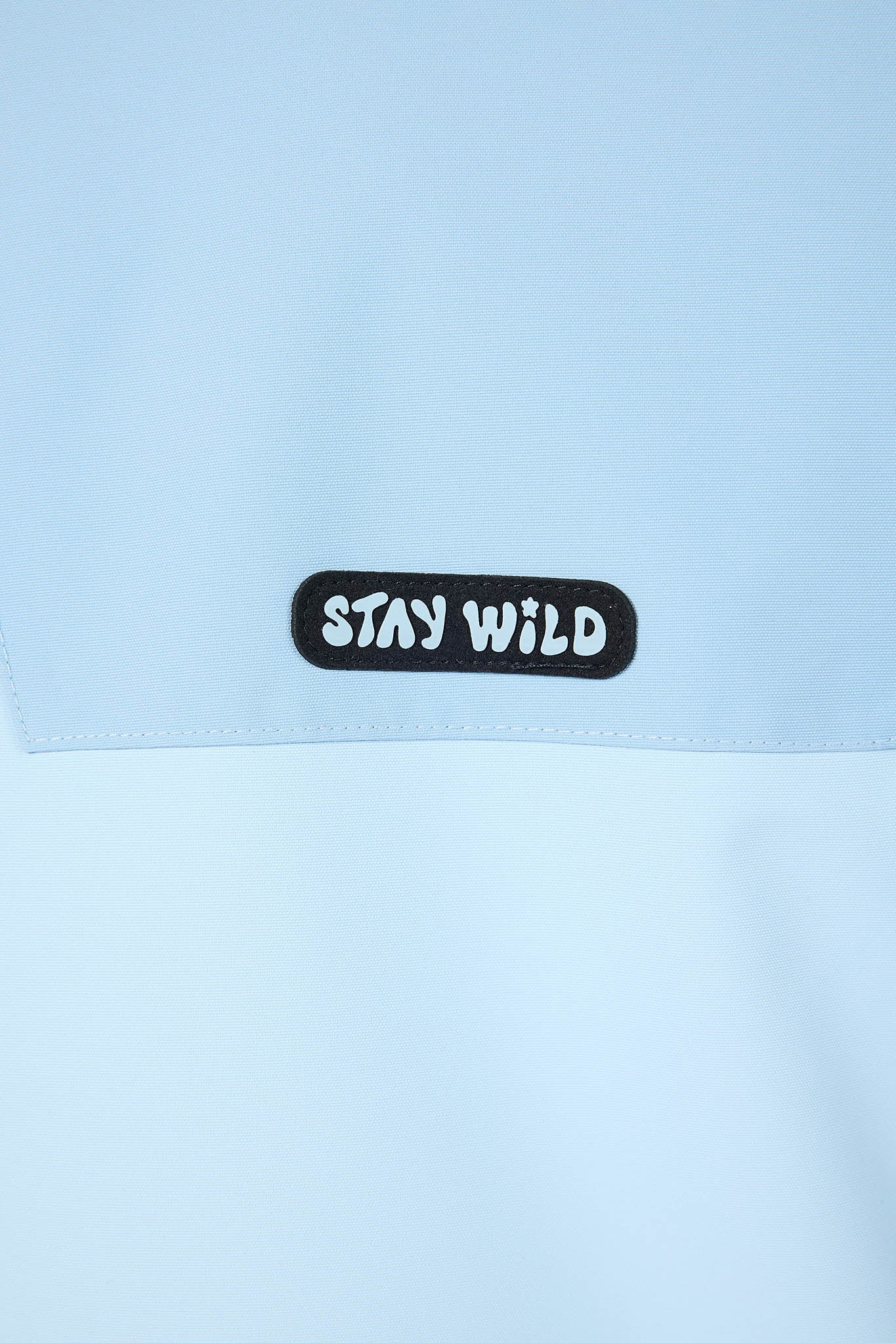 close up of blue stay wild tag