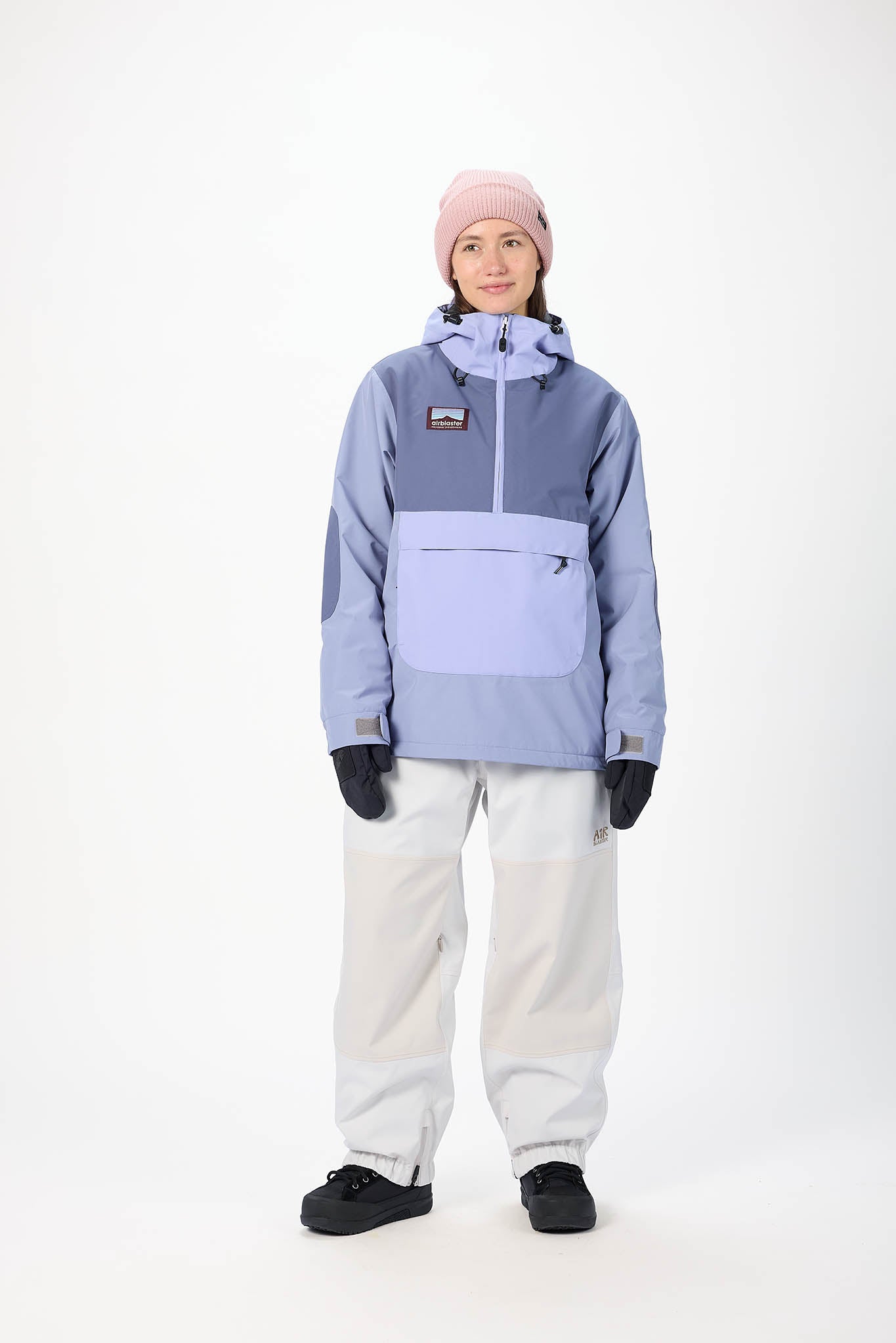 Person wearing a light blue snow jacket and white pants on a white background