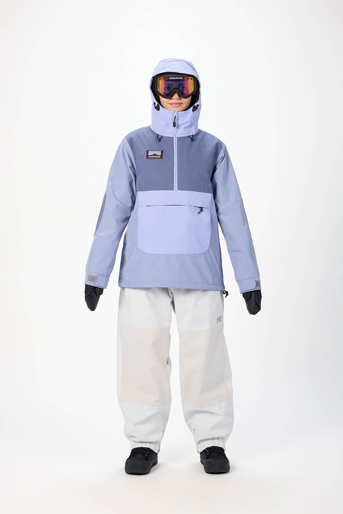 Person wearing a light blue snow jacket and white pants on a white background