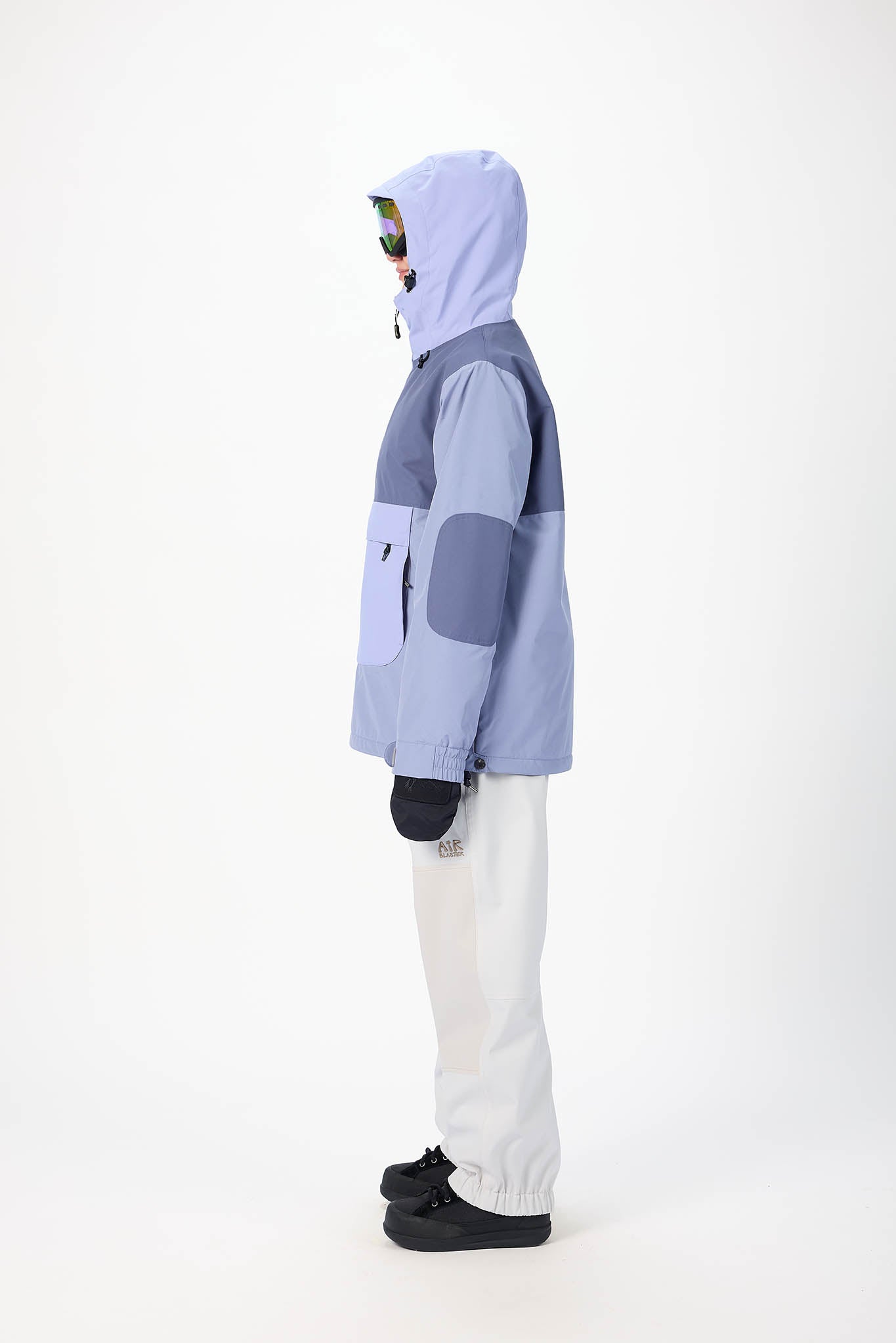 Person wearing a light blue and gray jacket with white pants on a white background