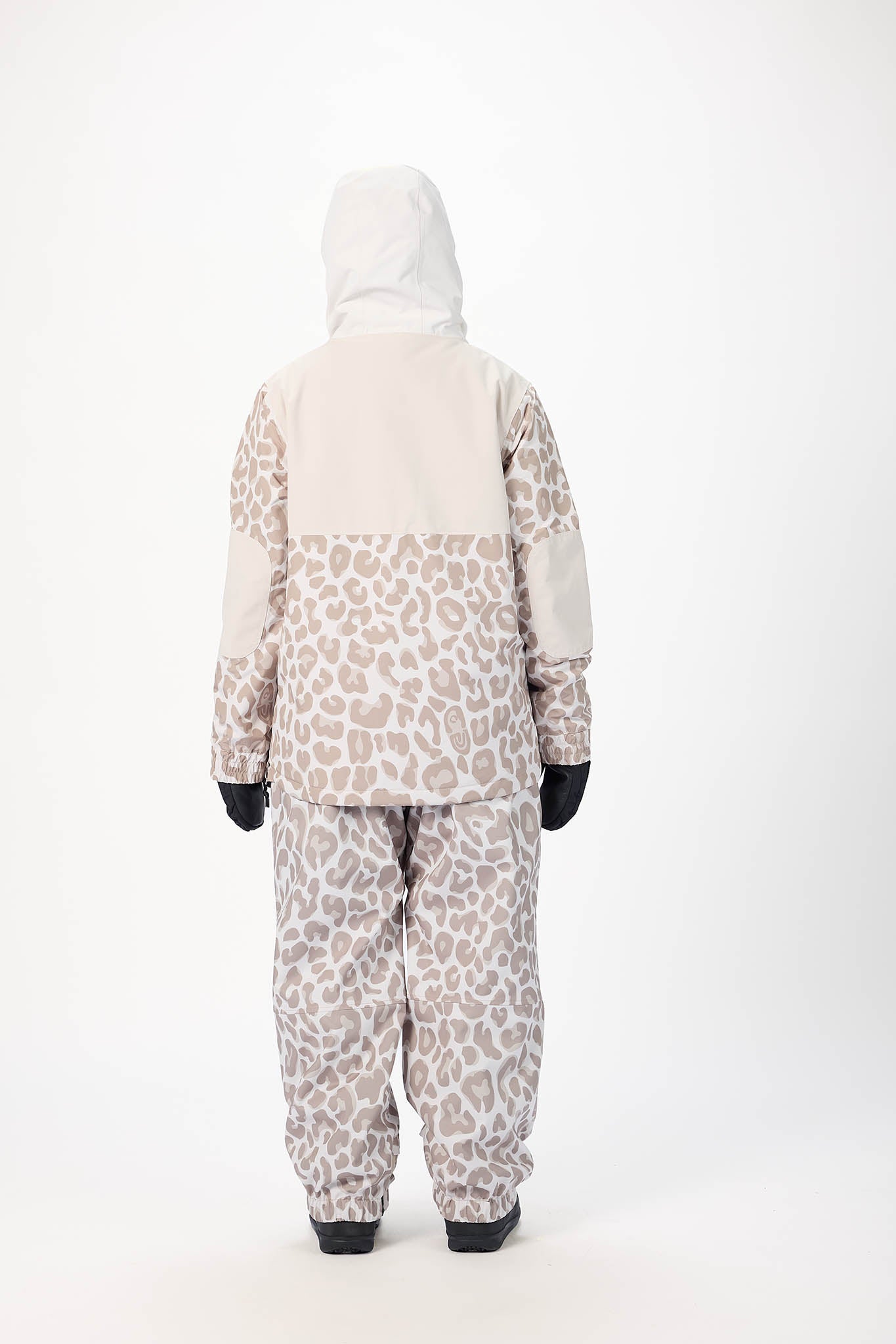 Person wearing a leopard print snowsuit on a white background