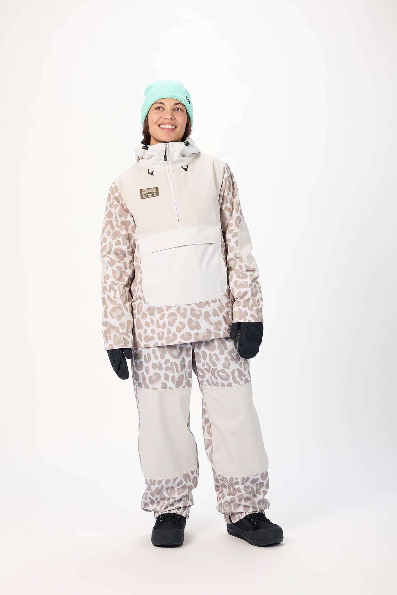 Person wearing a leopard print snowsuit with a white vest on a white background