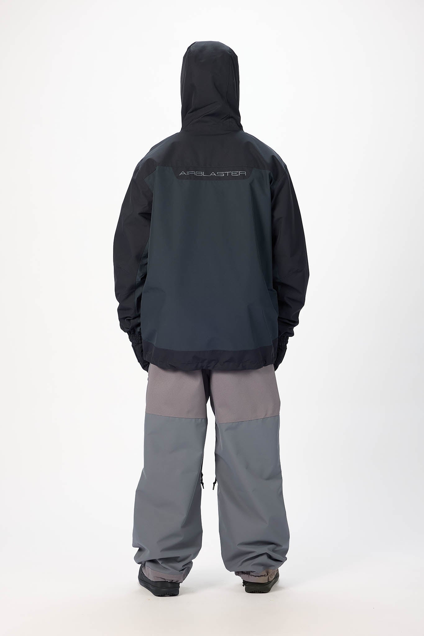 Person wearing a black and gray snowsuit with 'Appalachian' branding on the back, standing against a white background.