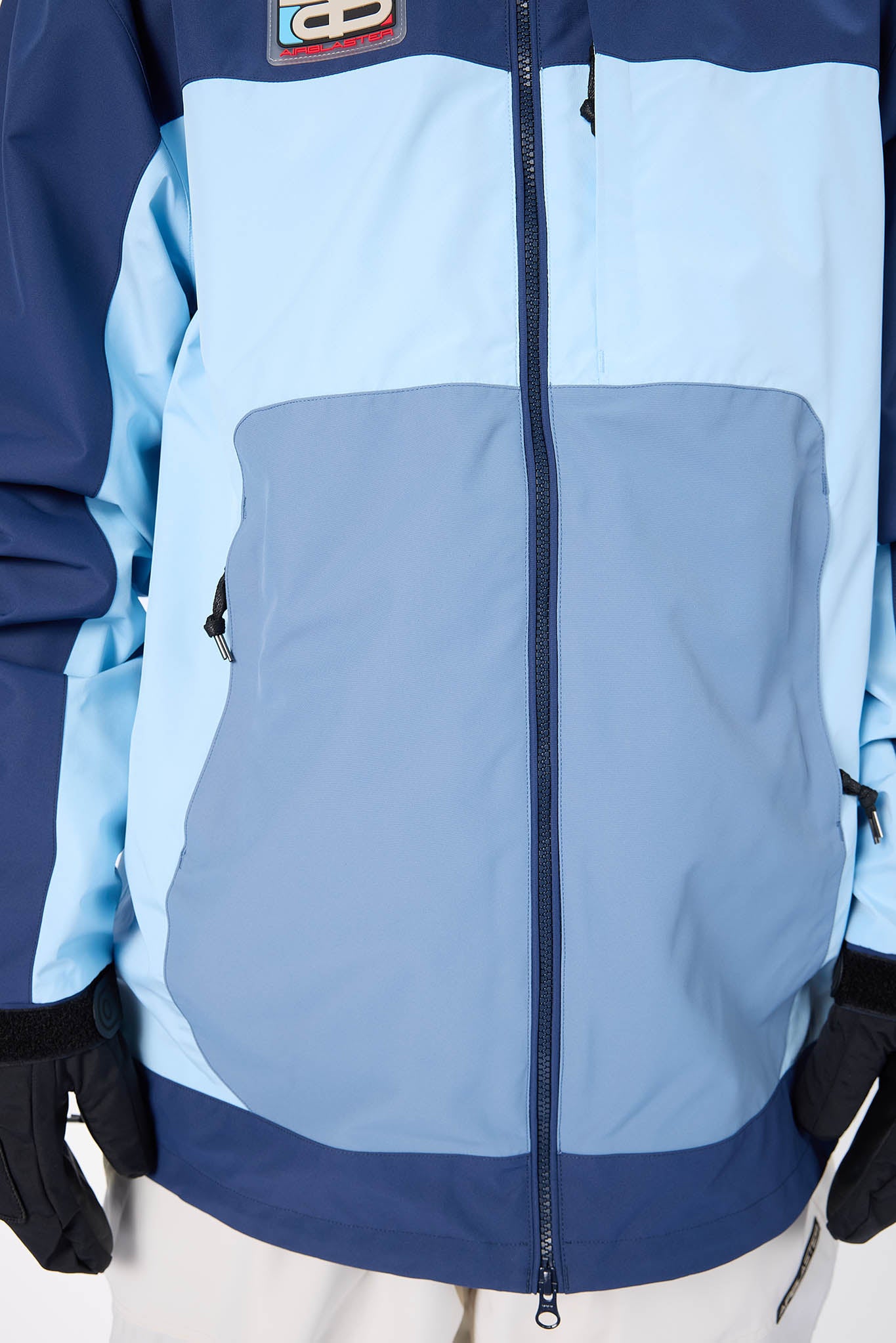 Light blue and navy jacket with a visible brand logo on a white background