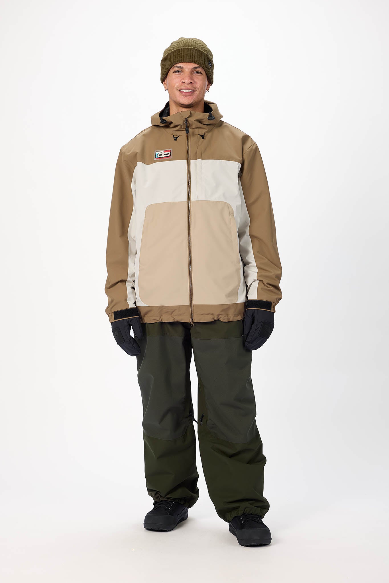 Person wearing a two-tone jacket and pants with a white background