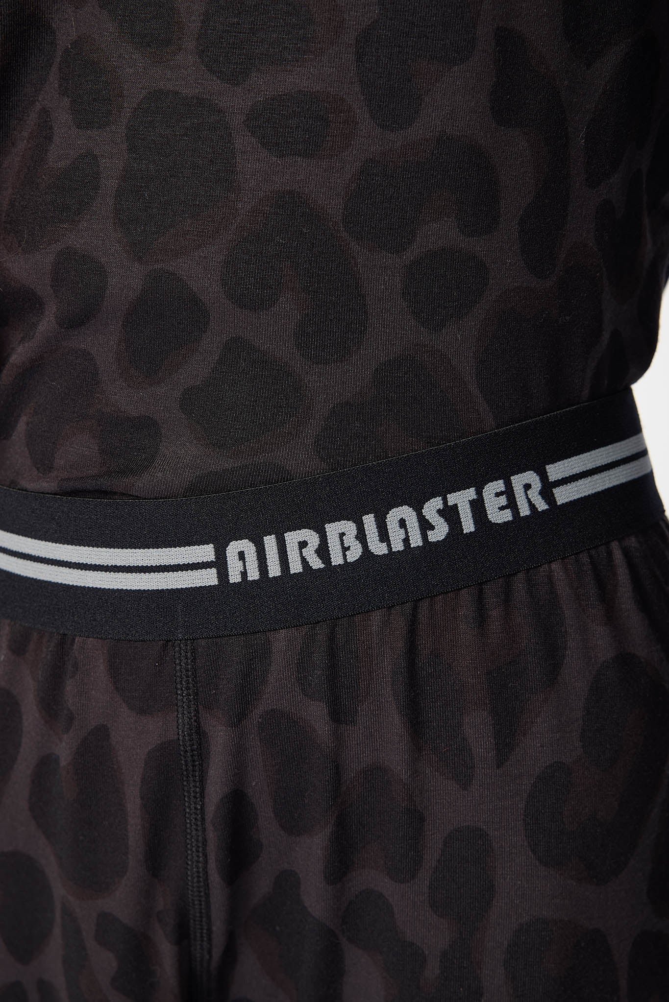 Close up of base layer product showing stitching details of the Black leopard pattern